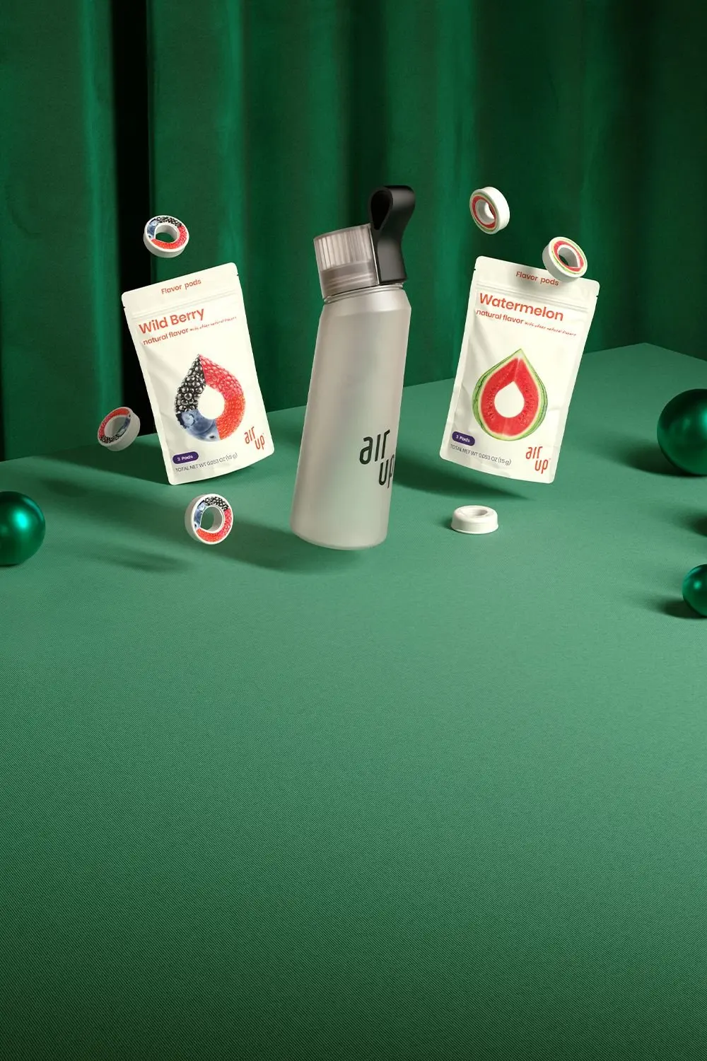 A Pearl White air up bottle sits in a holiday scene with wild berry and watermelon pods