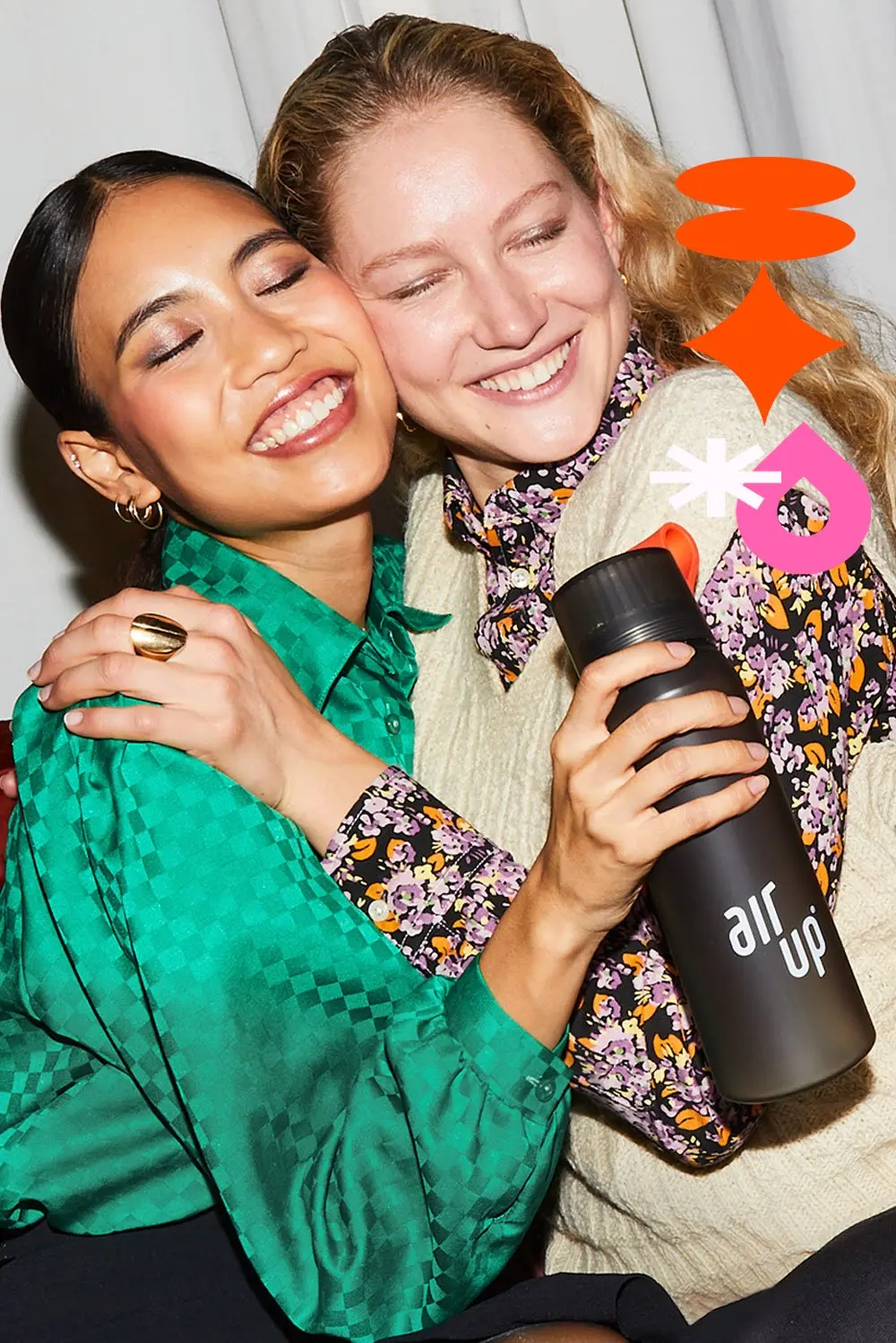 friends embrace with scent flavored water bottle